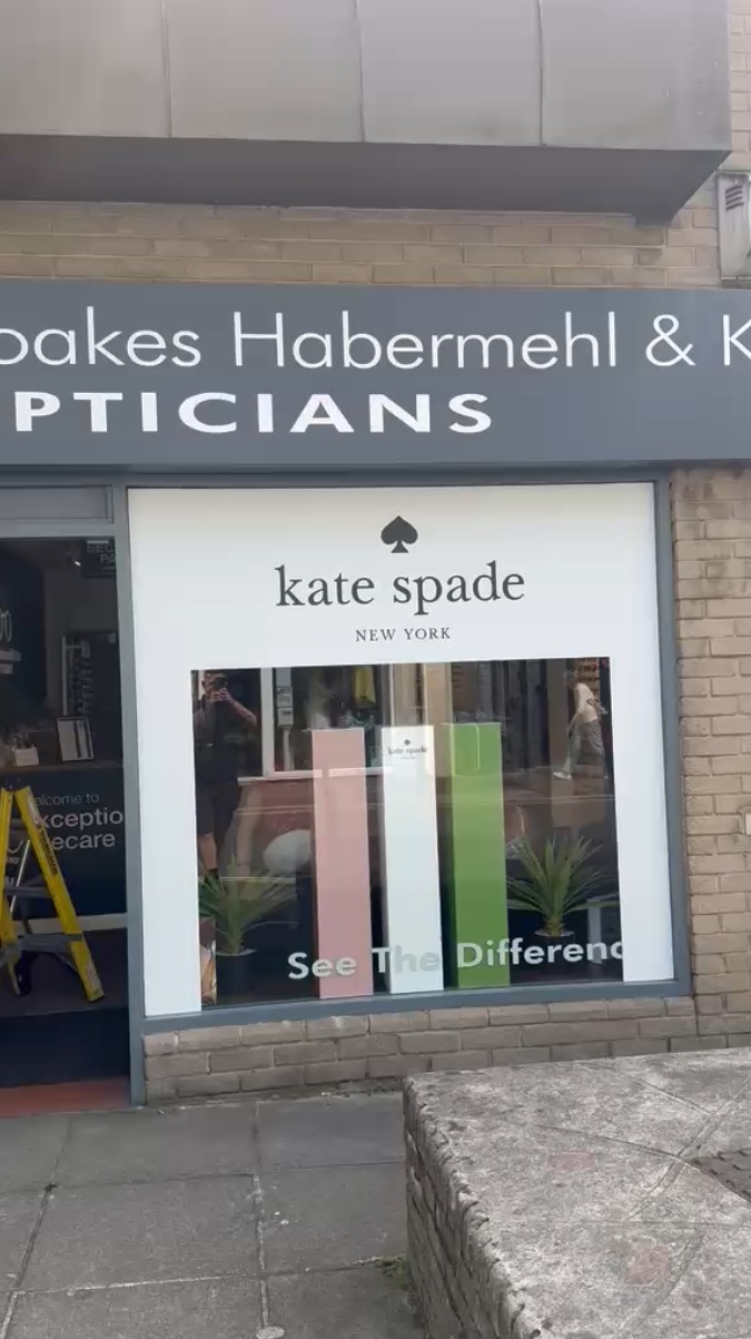 Noakes Habermehl & Kerr Opticians shopfront in Plymouth with Kate Spade New York window display, after aluminium door repair