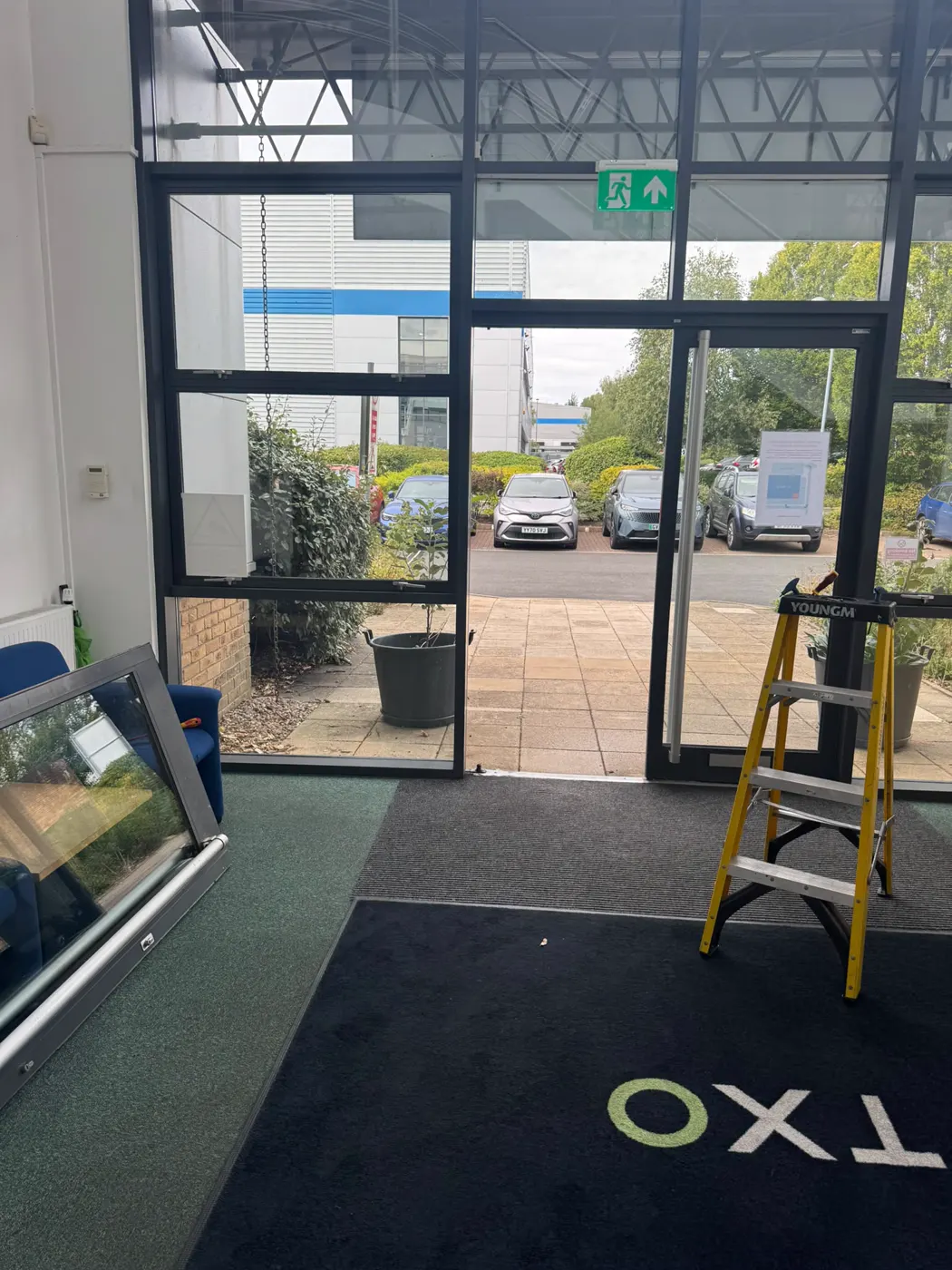 TXO reception in Chepstow with the aluminium entrance door leaf removed and the frame open for transom closer replacement