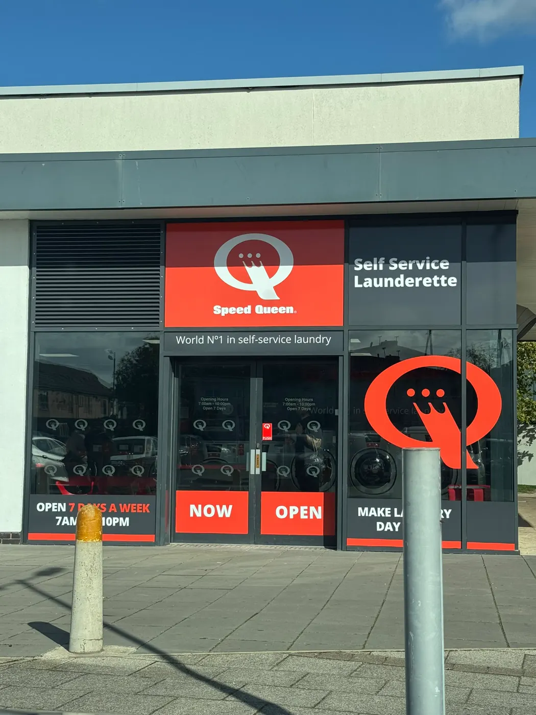 Speed Queen self-service launderette shopfront in Liverpool with double aluminium entrance doors before transom closer replacement