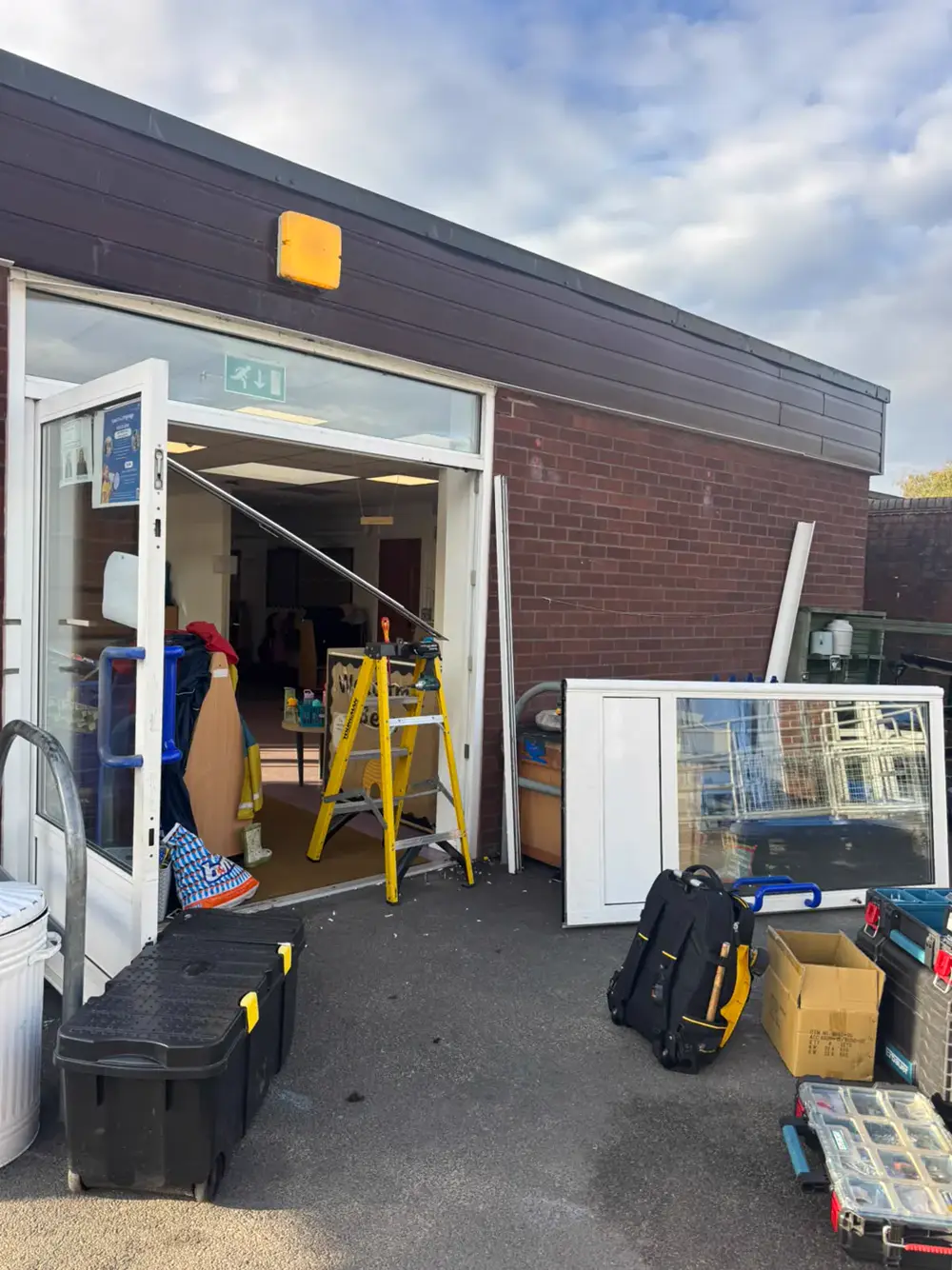 Classroom external door at Westglade Primary School with the aluminium leaf removed and leaning against the wall during transom closer replacement